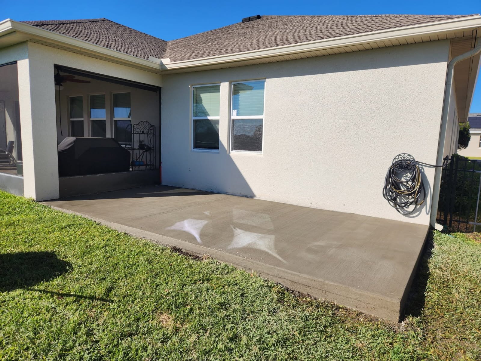 New concrete slab poured beside a screened lanai on a Florida home