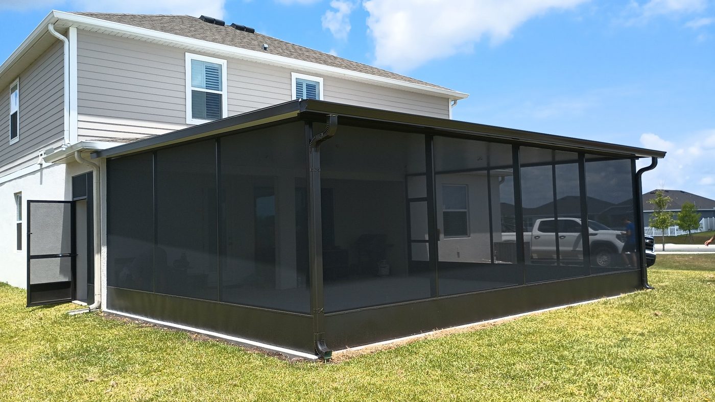 Finished screened-in lanai with bronze framing on a two-story home