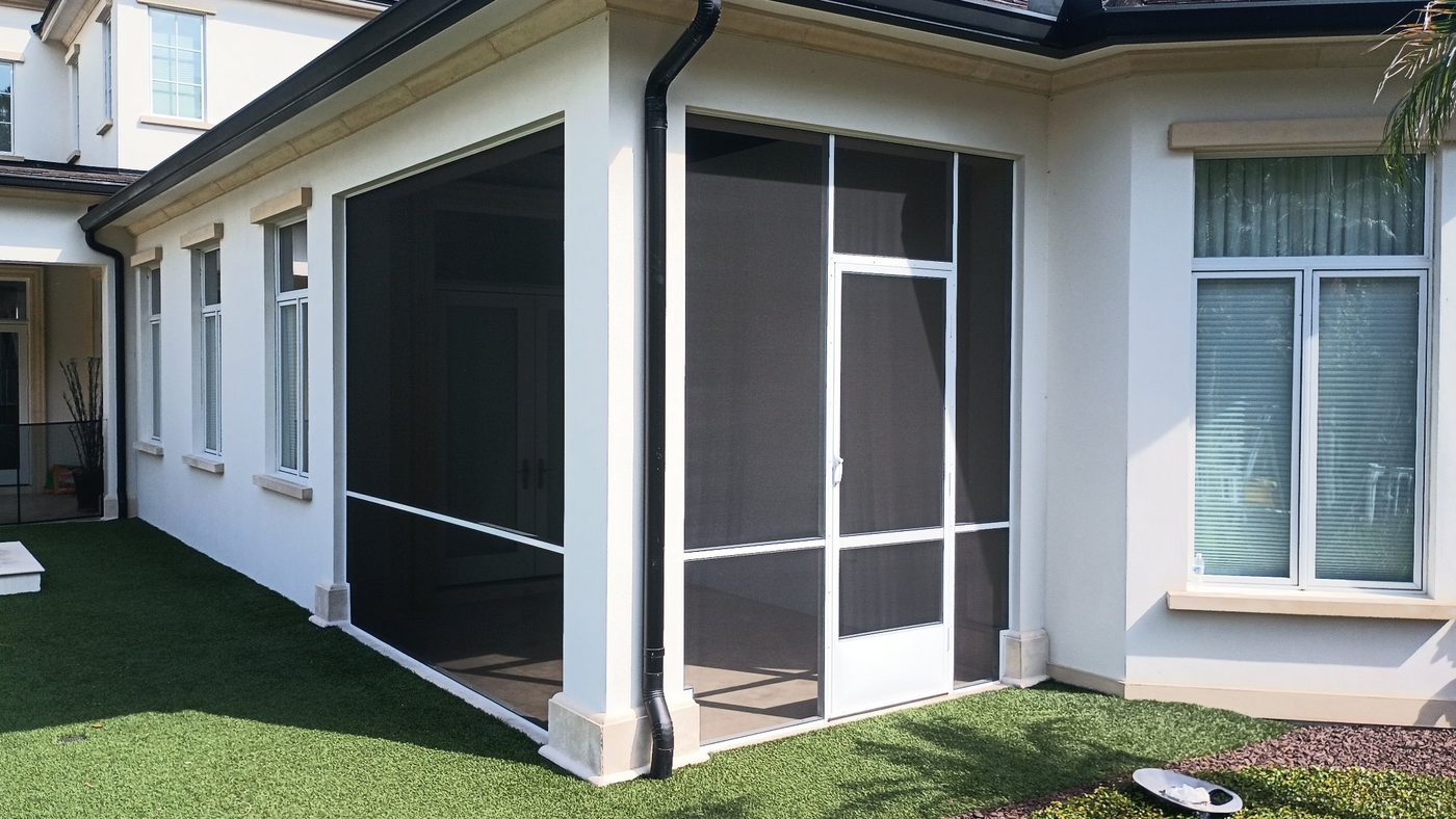 Screened patio with white framing on a stucco home