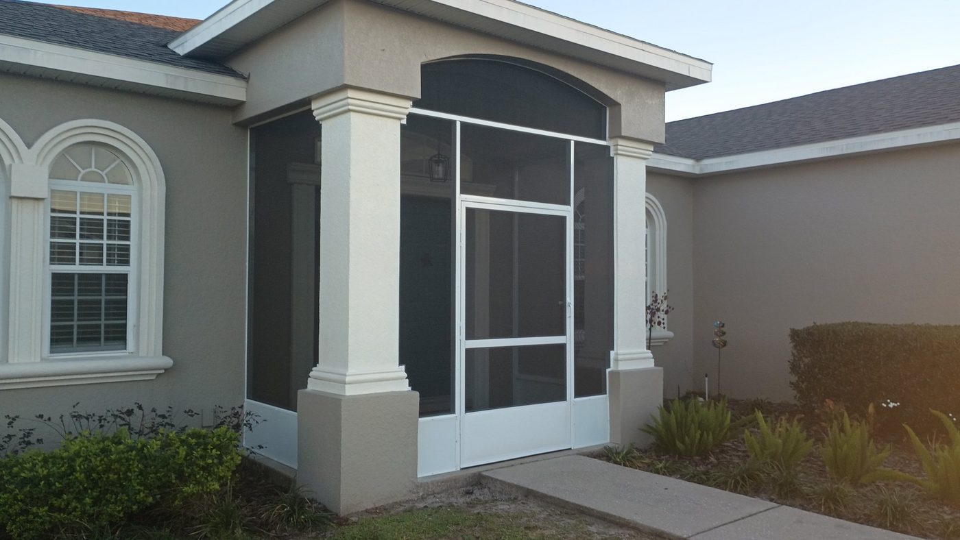 Screened entryway with white columns and screen door