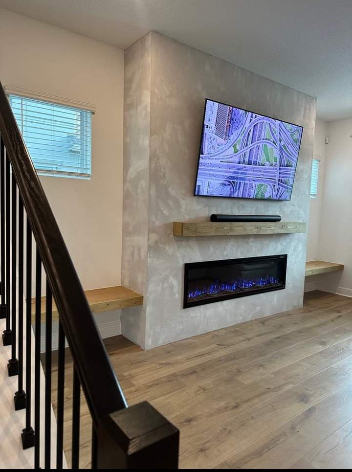 Fireplace wall with a limewash finish and a mounted TV