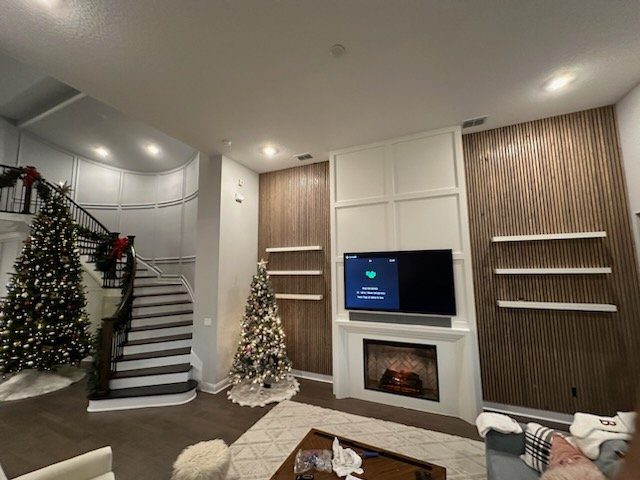 Wood-paneled fireplace wall beside a staircase