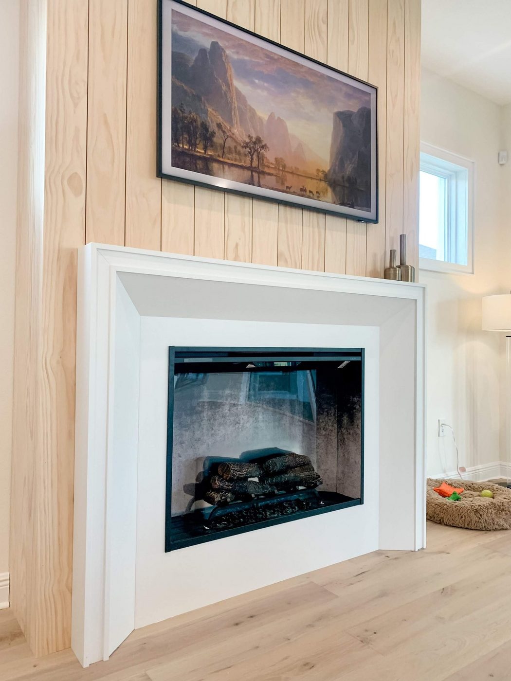 Fireplace with a light wood shiplap surround