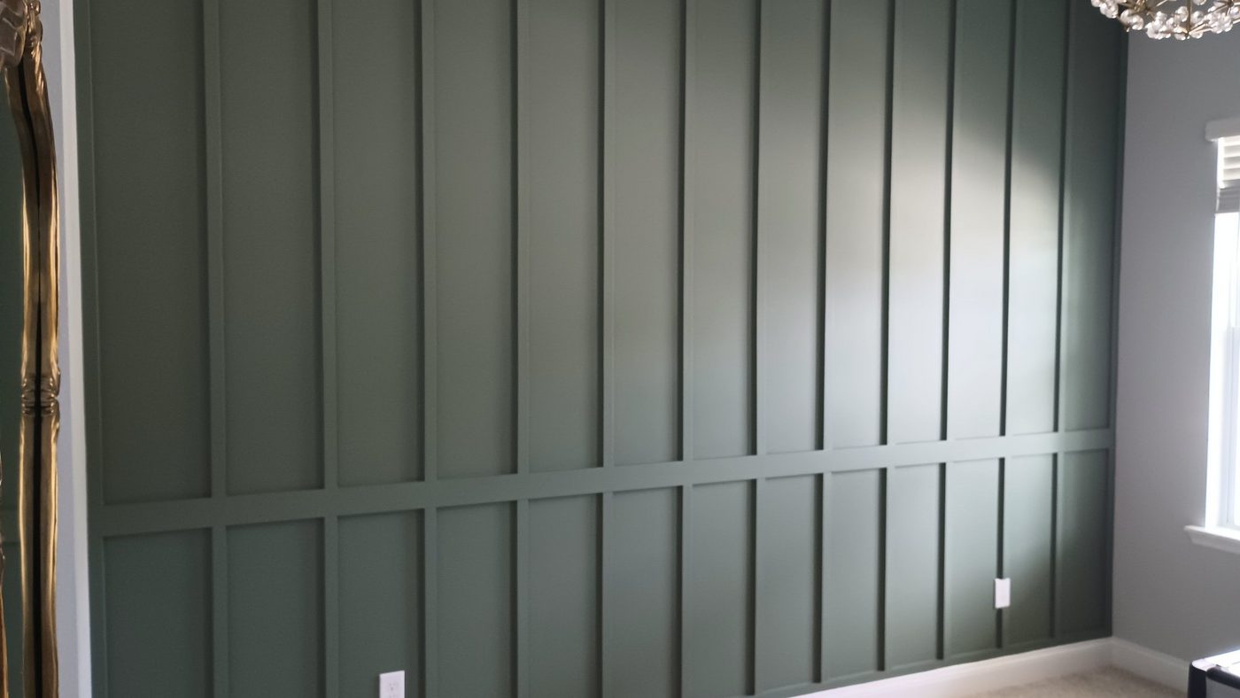 Dark green vertical board-and-batten accent wall