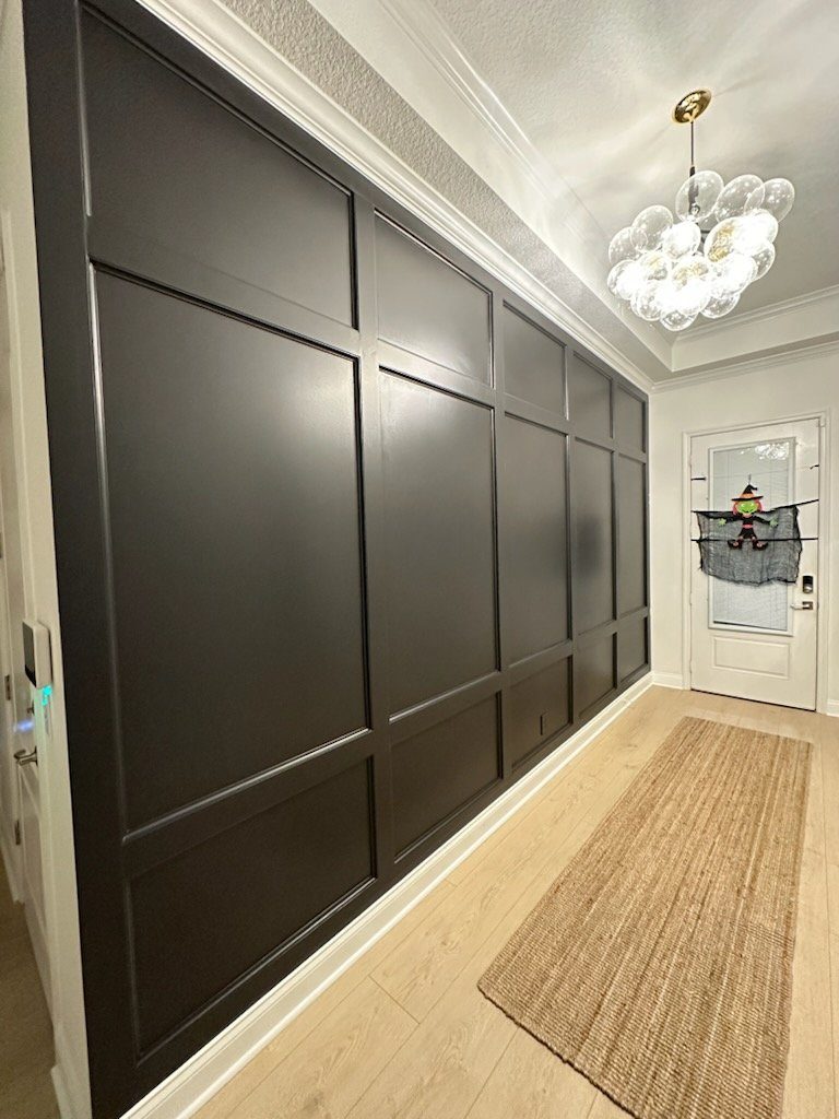 Hallway with dark shaker-style wall paneling