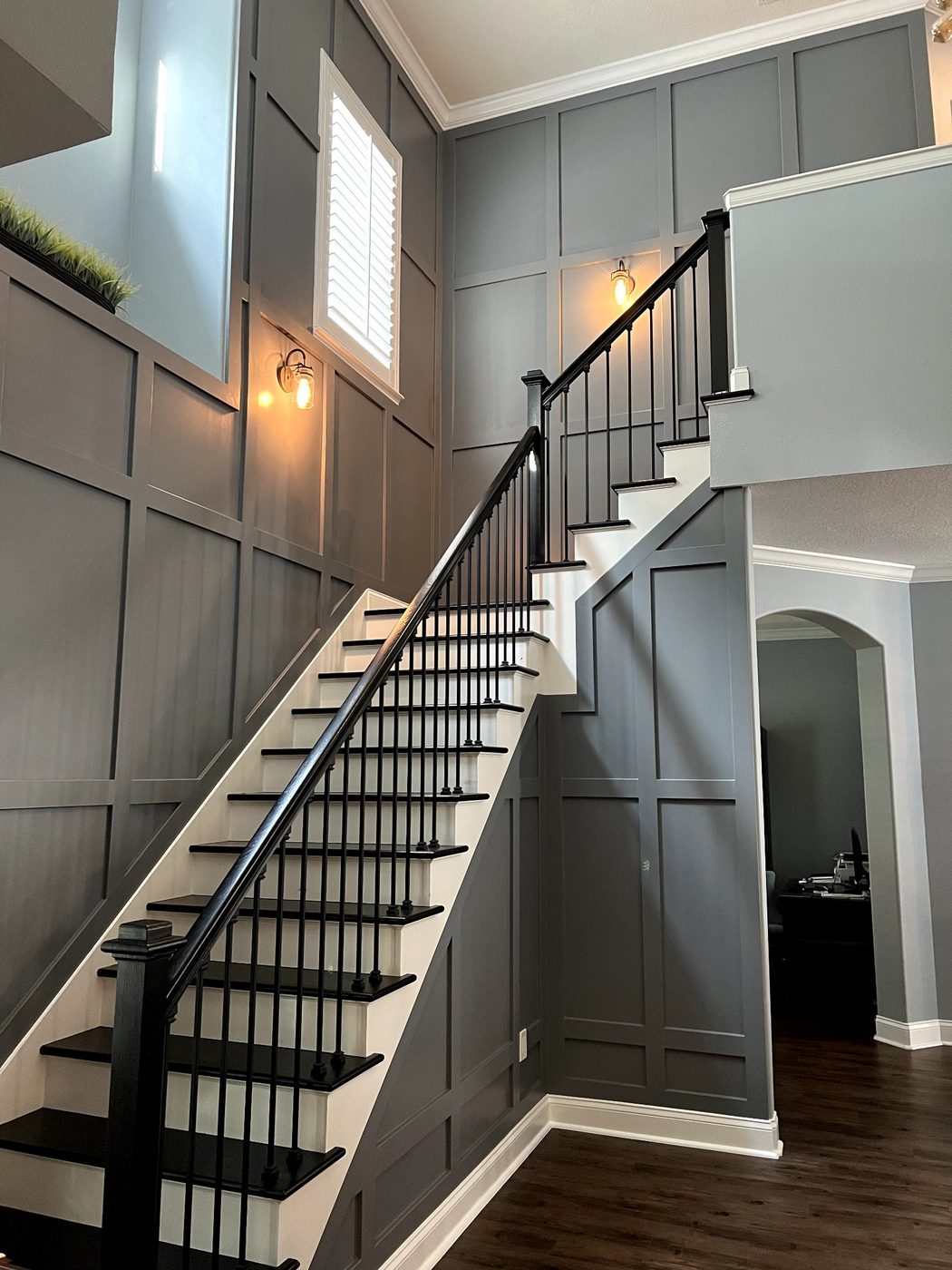 Staircase with dark board-and-batten wall panels