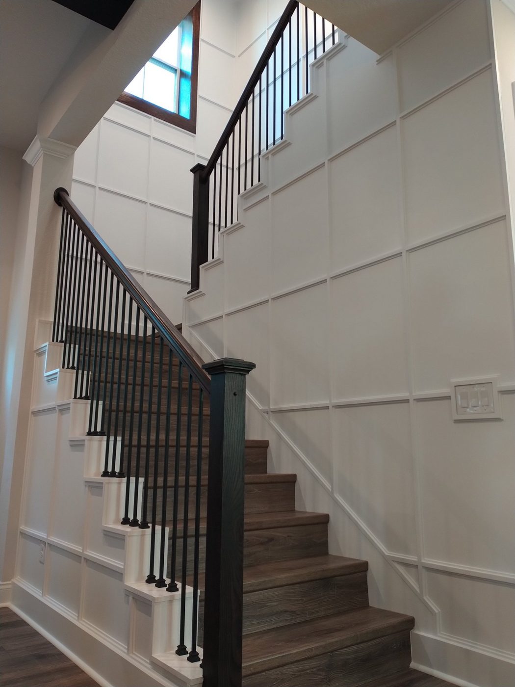 Stairway with a white board-and-batten accent wall