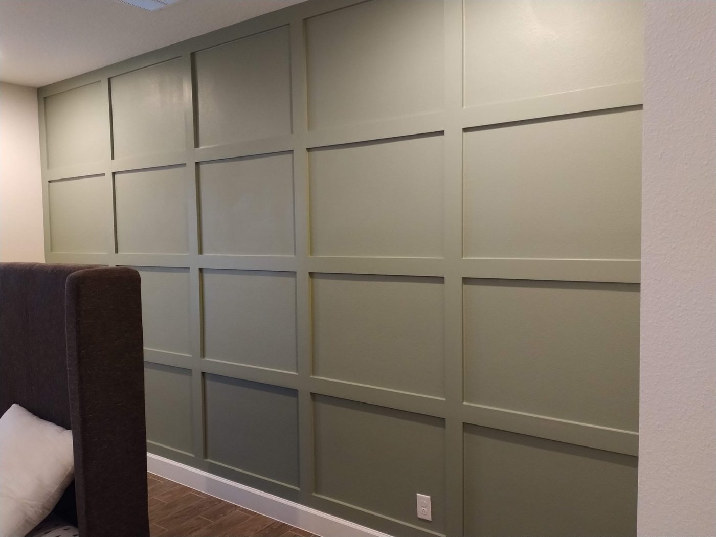 Bedroom wall with taupe shaker panel wainscoting