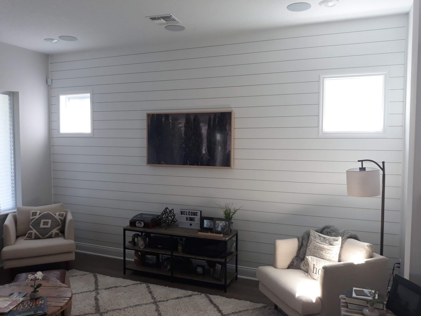 Living room with a white horizontal shiplap wall and TV