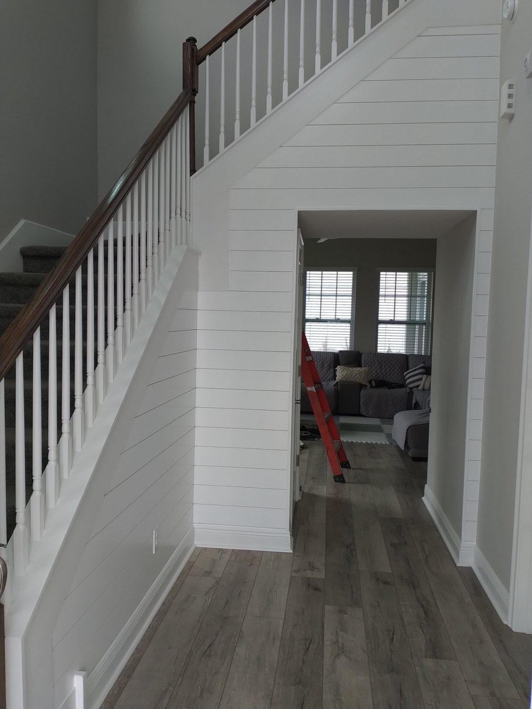 Stairwell lined with white shiplap