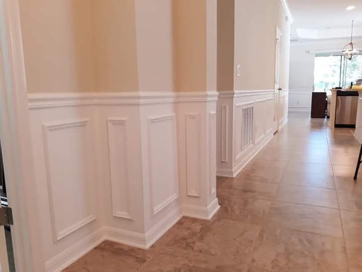 Hallway with white shadow-box wainscoting