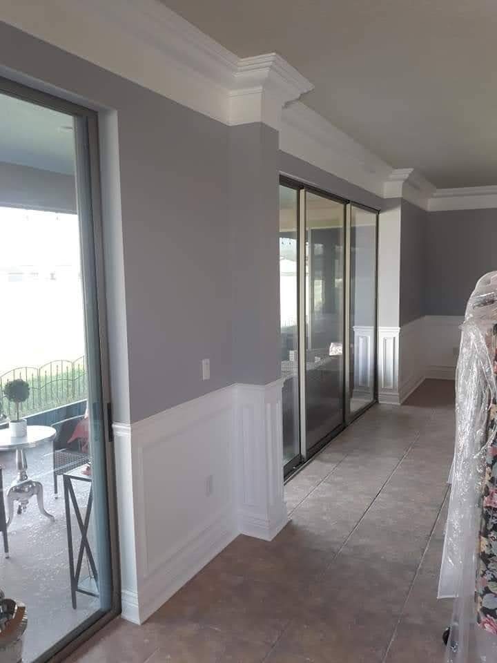 White wainscoting along a wall by sliding glass doors