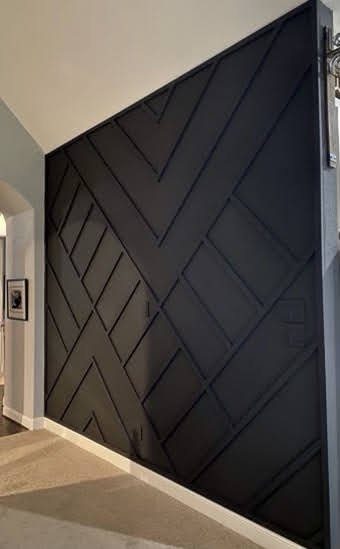 Dark green chevron accent wall in an entryway