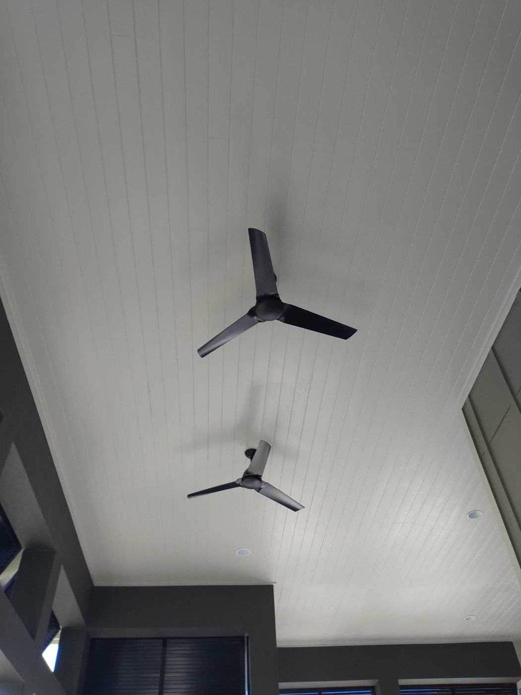 White beadboard porch ceiling with ceiling fans