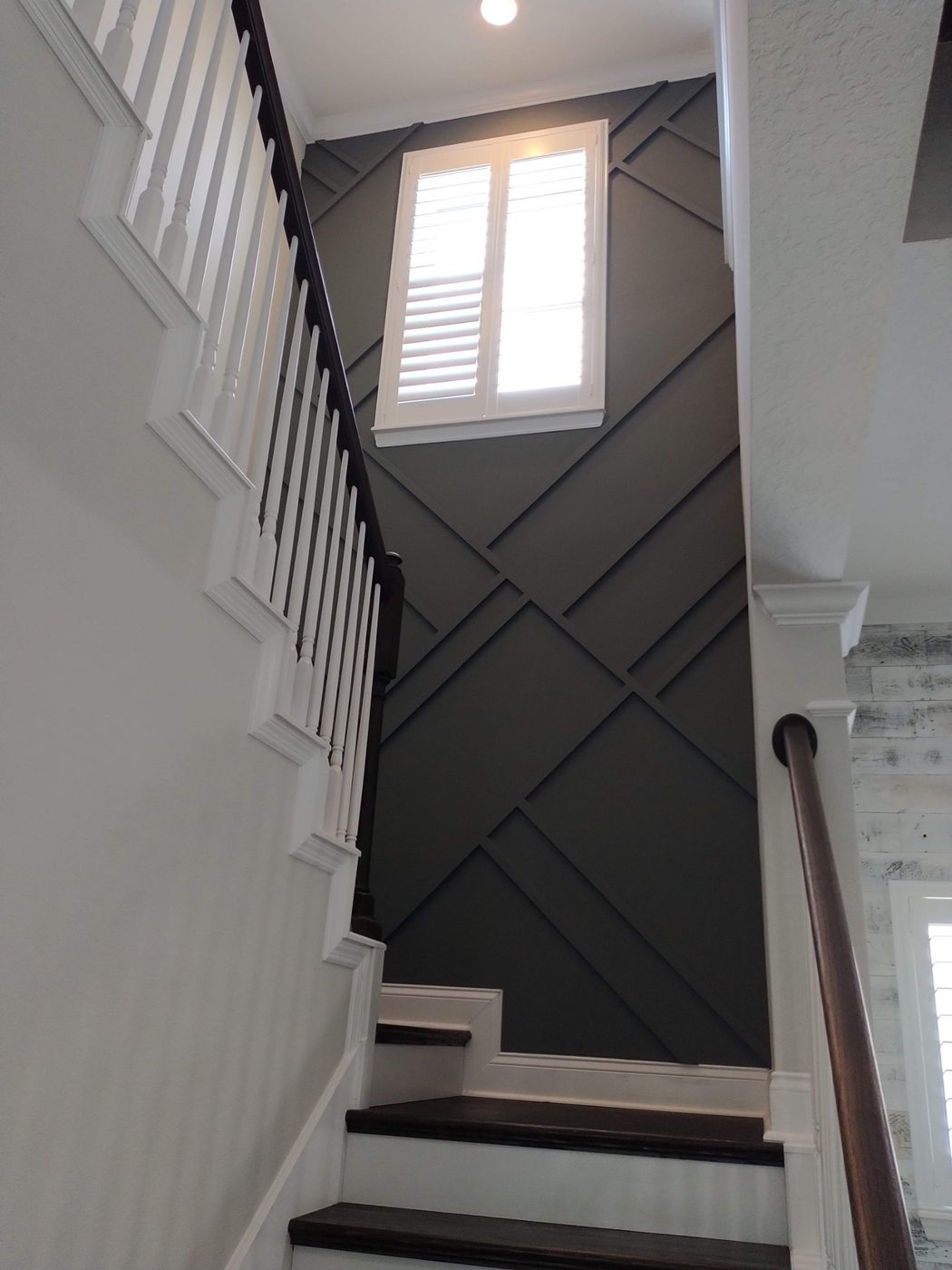 Gray chevron accent wall along a stairway