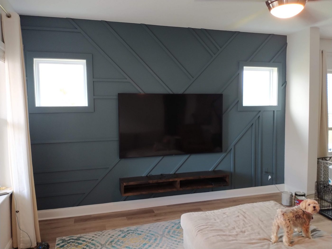 Gray geometric accent wall with a mounted TV