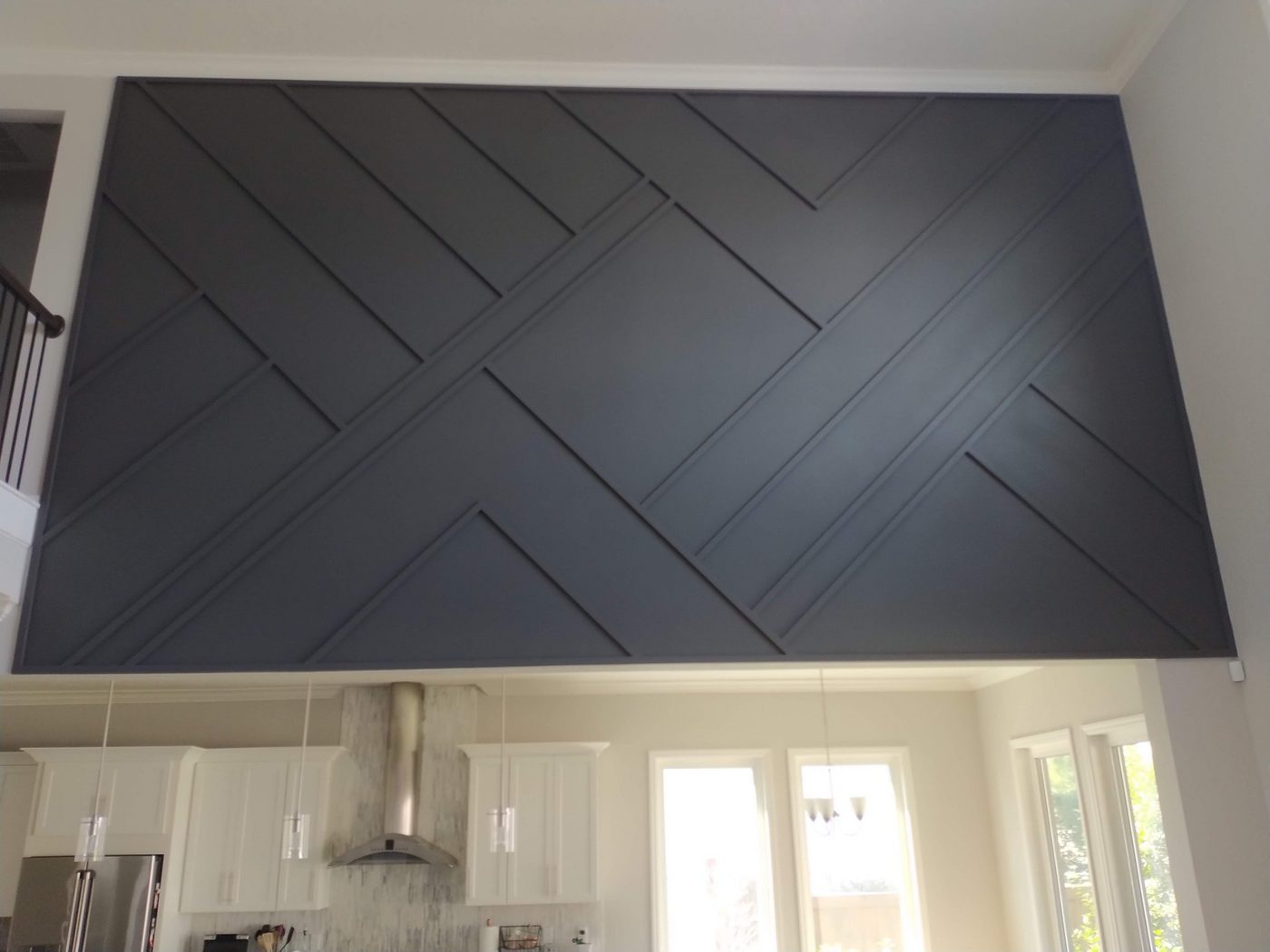 Dark navy geometric accent wall above a kitchen