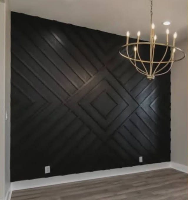 Dark green geometric accent wall in a dining room