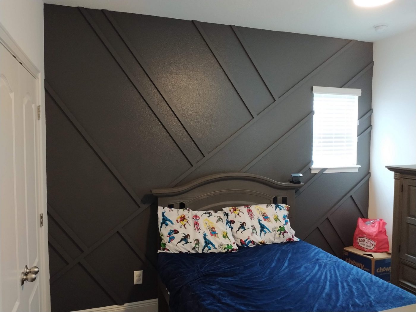 Bedroom with a dark chevron accent wall