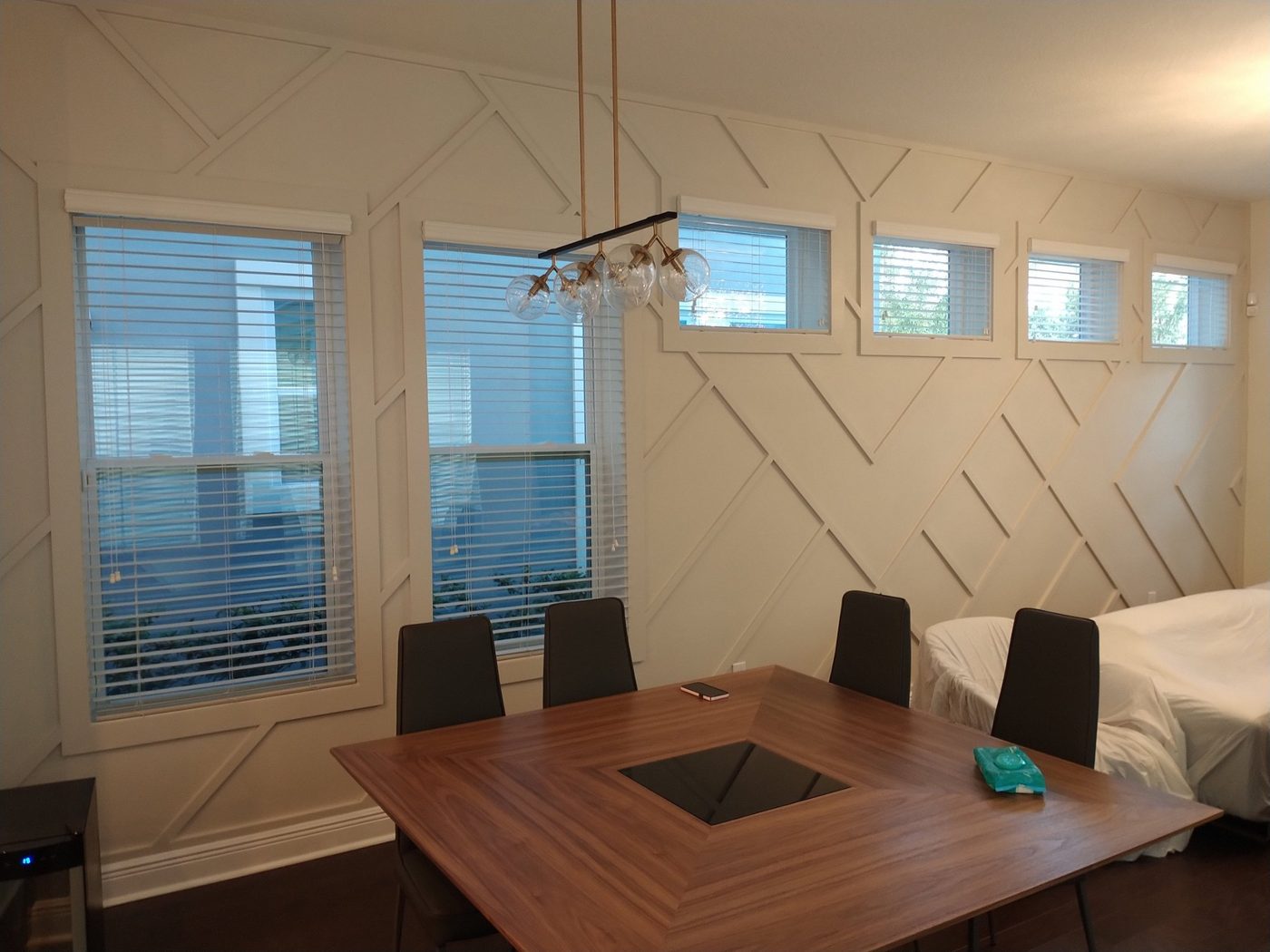 Dining room with a white geo accent wall
