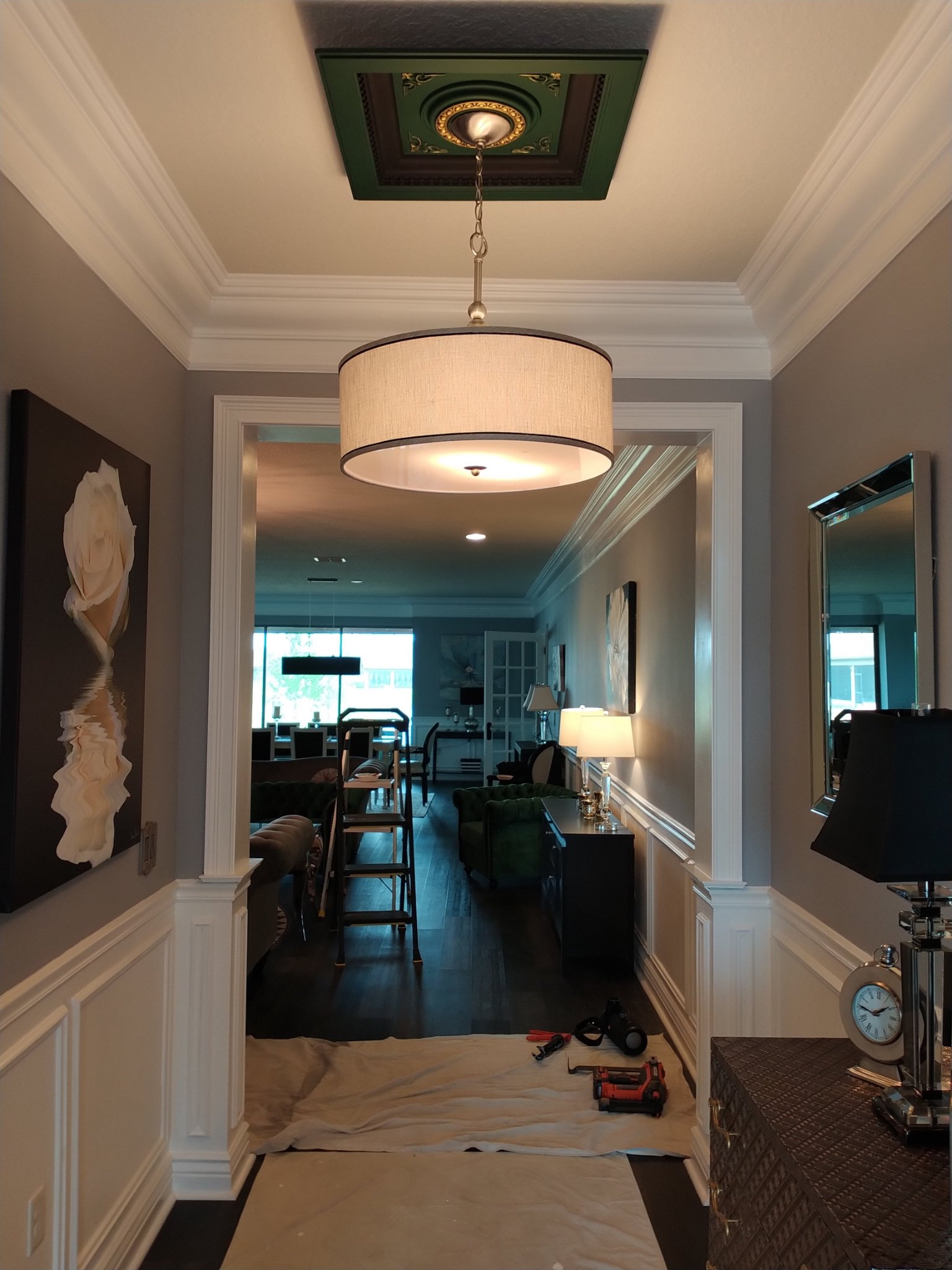 Hallway with white crown molding and a ceiling medallion