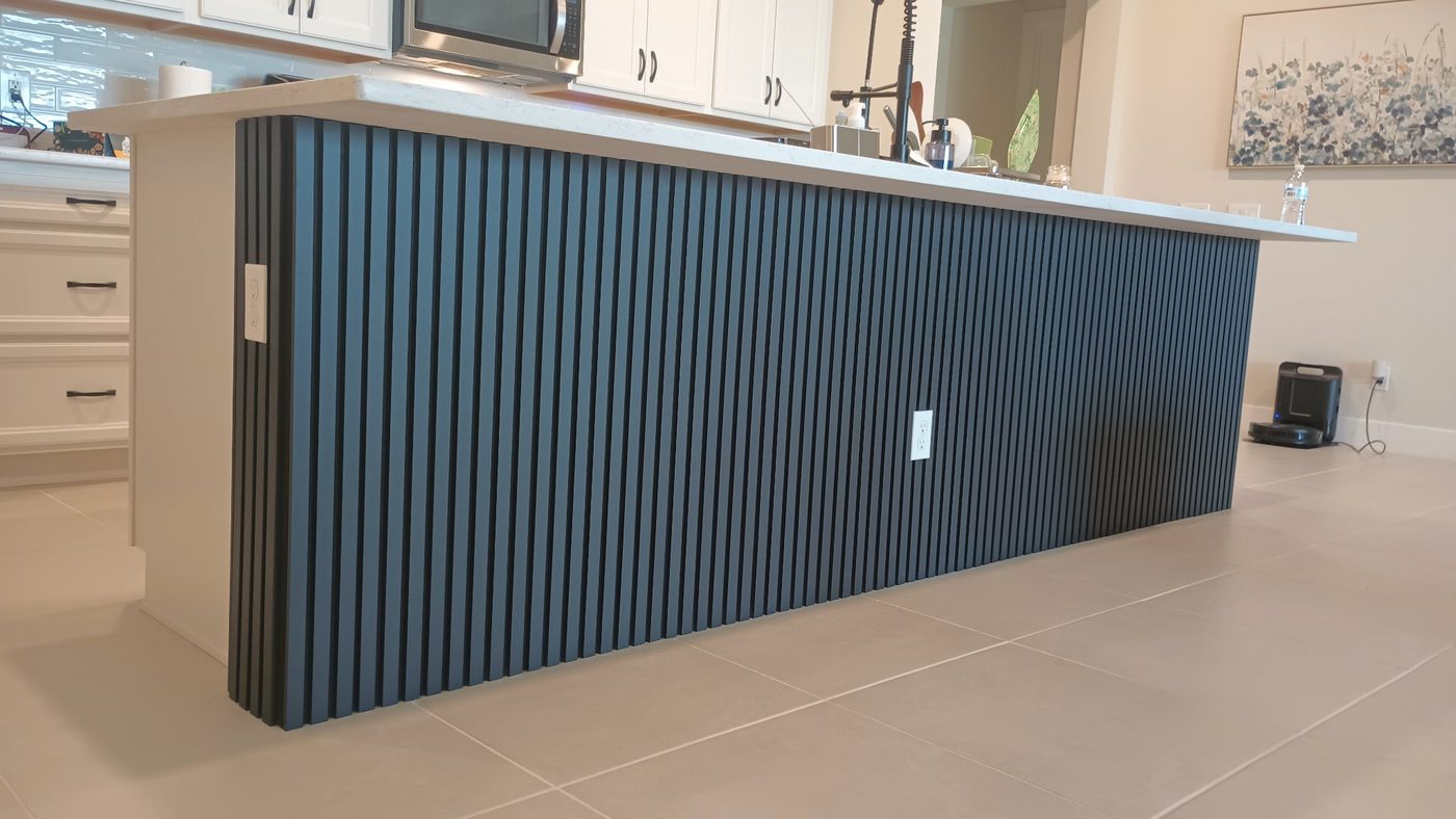 Kitchen island wrapped in dark vertical slats