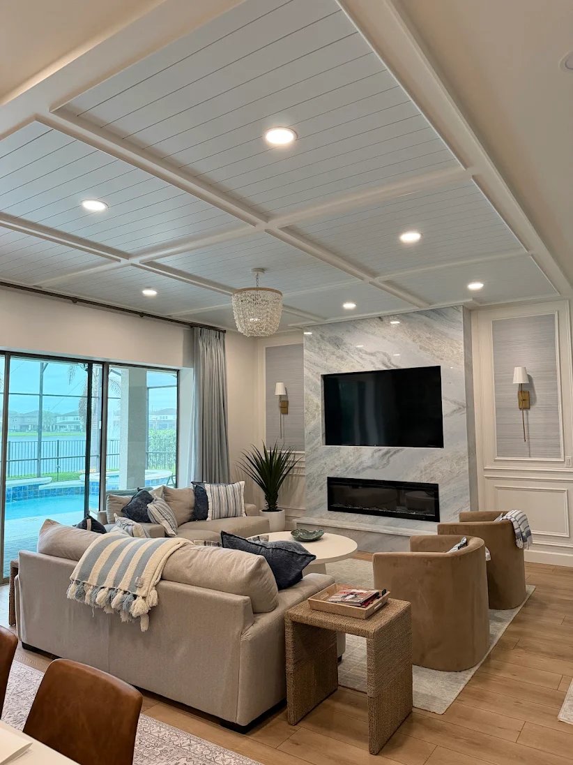 Living room with a coffered ceiling and shiplap panels