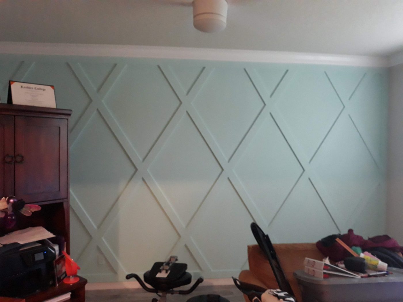 Light teal geometric diamond accent wall in a home office