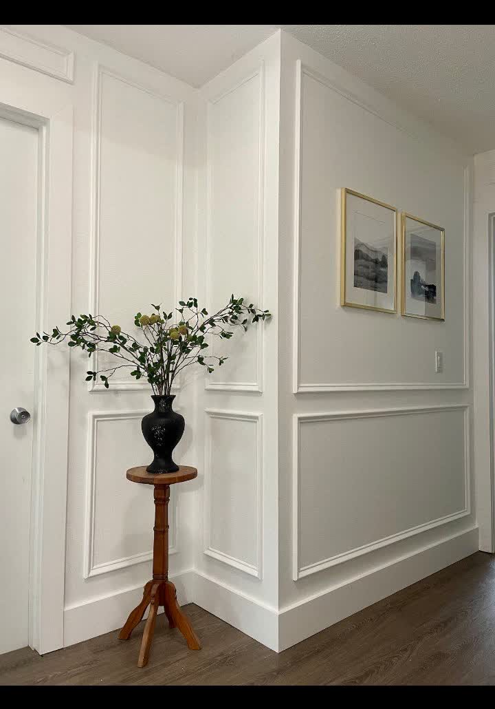 Hallway with white shadow-box trim on the walls